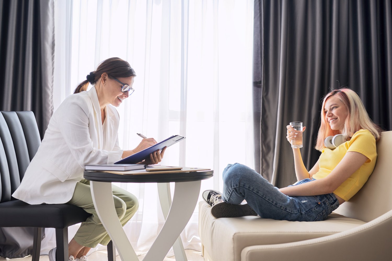 Woman Social Worker Talking to Teenage Girl in Office