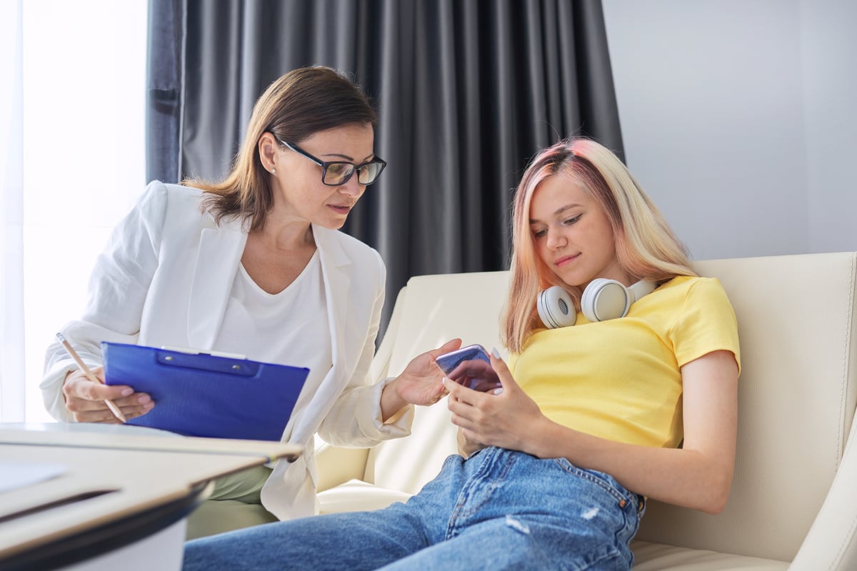 Woman Social Worker Talking to Teenage Girl in Office